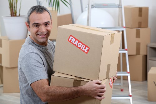 Flat removal team preparing boxes and furniture for a move in Oldoakcommon